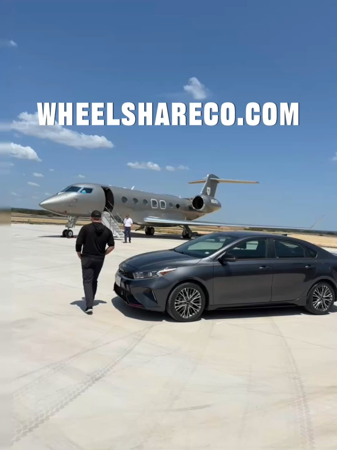 Kia Forte parked beside a private jet on the tarmac